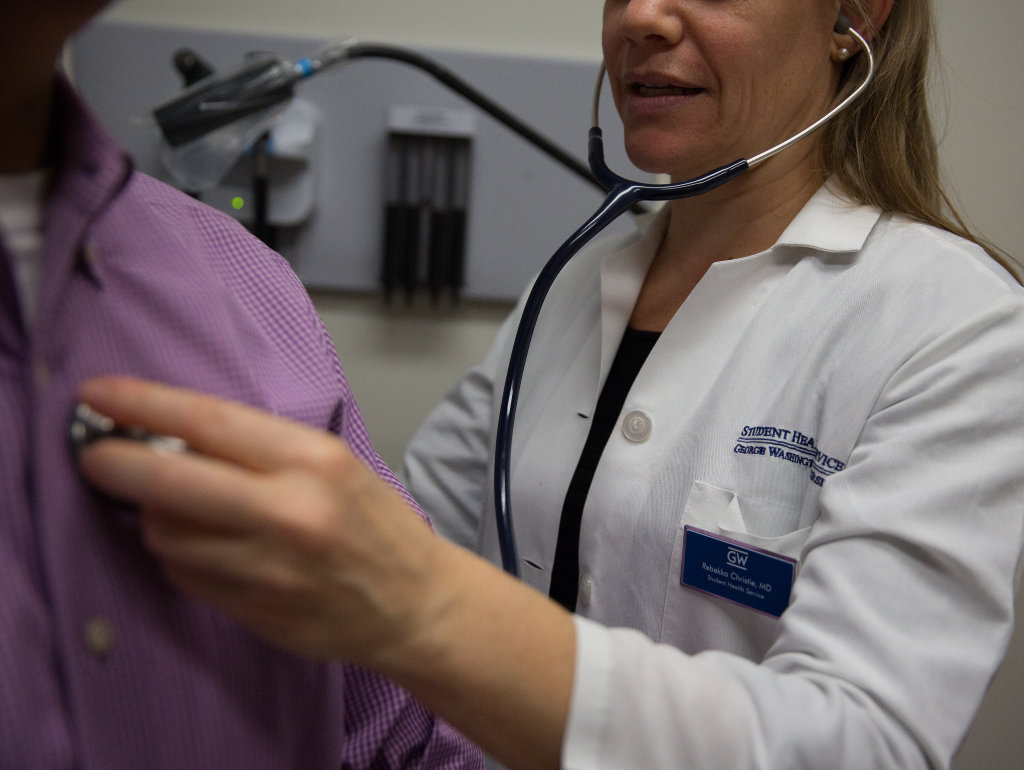 A medical doctor using a stethoscope