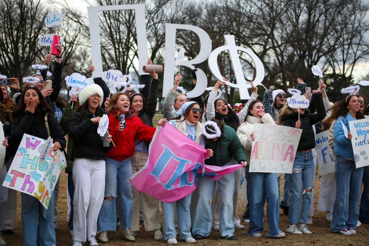Members of Pi Beta Phi cheer as new members run to their chapter on bid day.