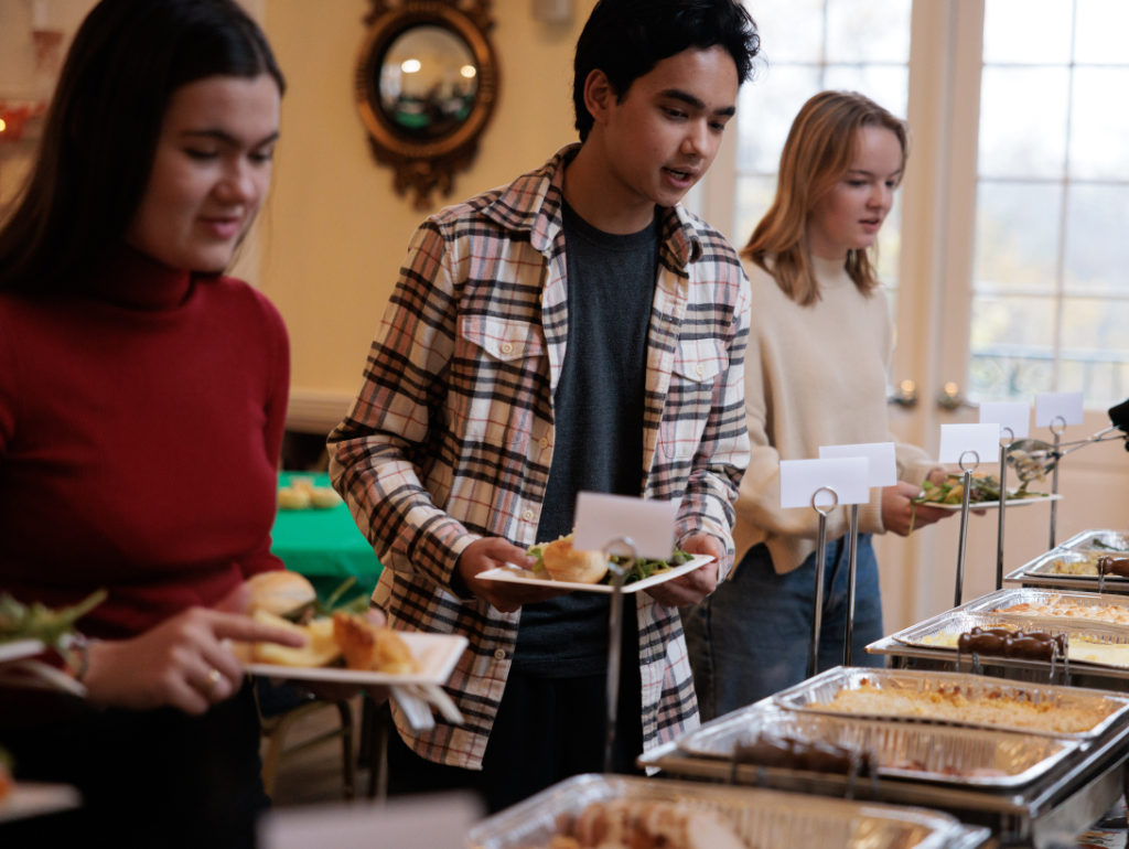 Students getting food at a Thanksgiving buffet in Post Hall