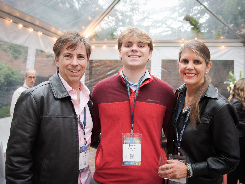 Two family members pose for a photo with their GW student at the Family Leadership Circle reception
