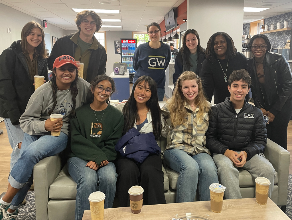 Colette posing for a photo with a large group of students at Buff & Brew