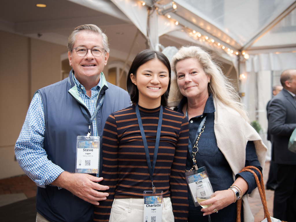 Two parents post with their GW student during Alumni & Families Weekend event
