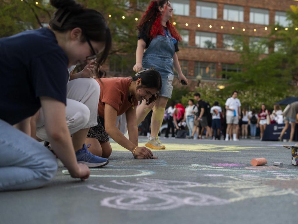 Three students drawing at the 2023 DSA chalk in