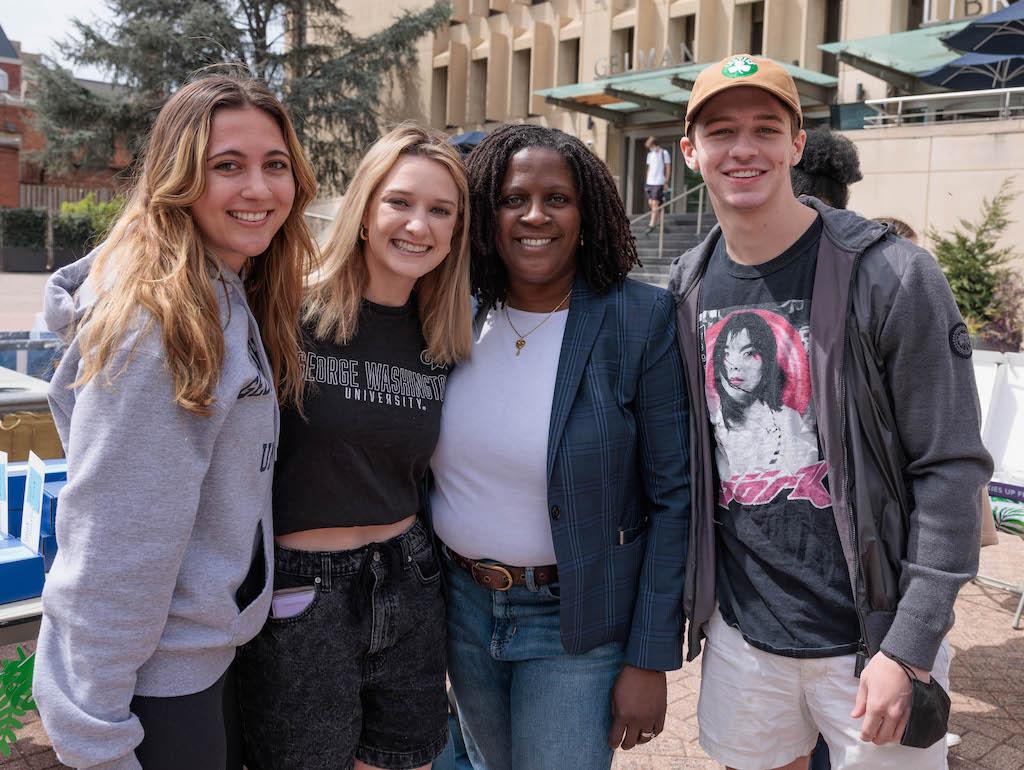 Vice Provost Colette Coleman poses with three GW students outside Gelman