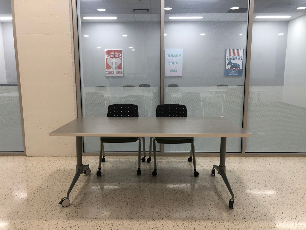 Table with two chairs set up on the B1 level of District House