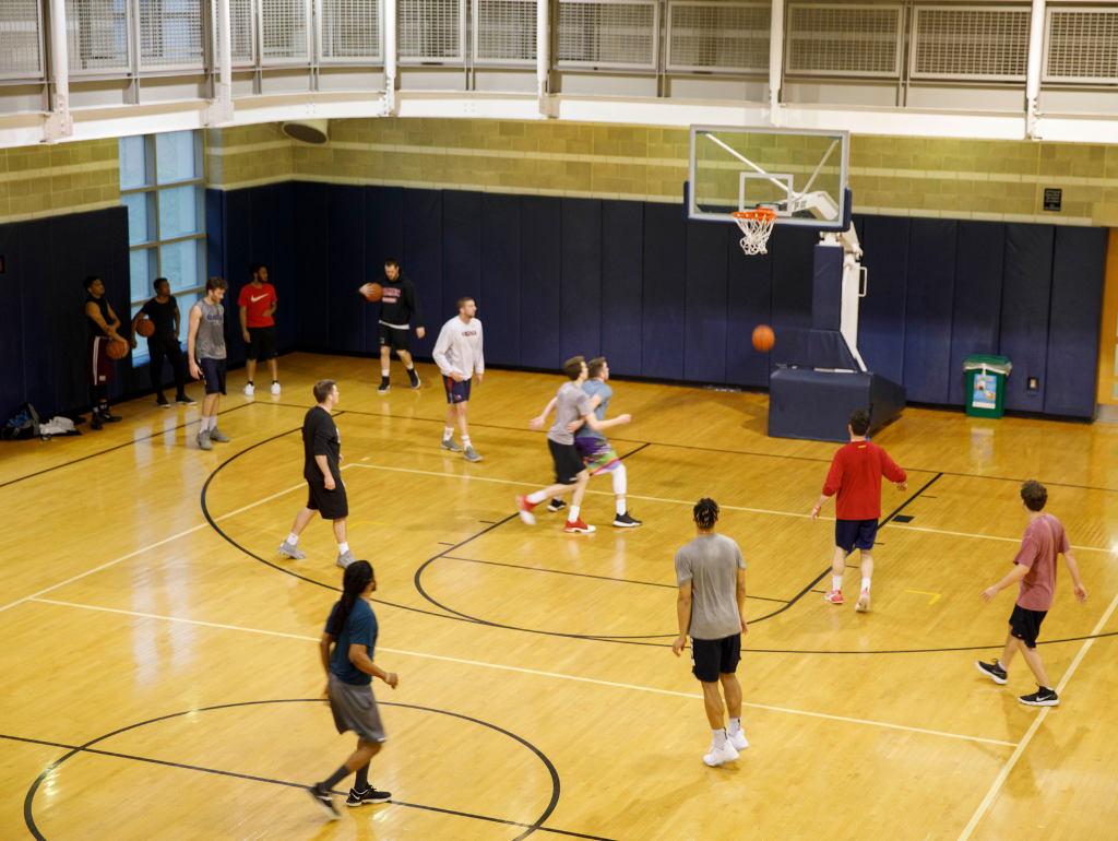 Several students playing a pick-up game of basketball in Lerner