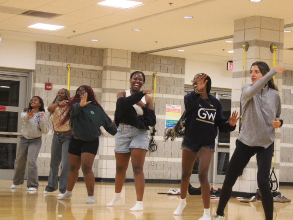 A group of six students engaged in a group fitness class