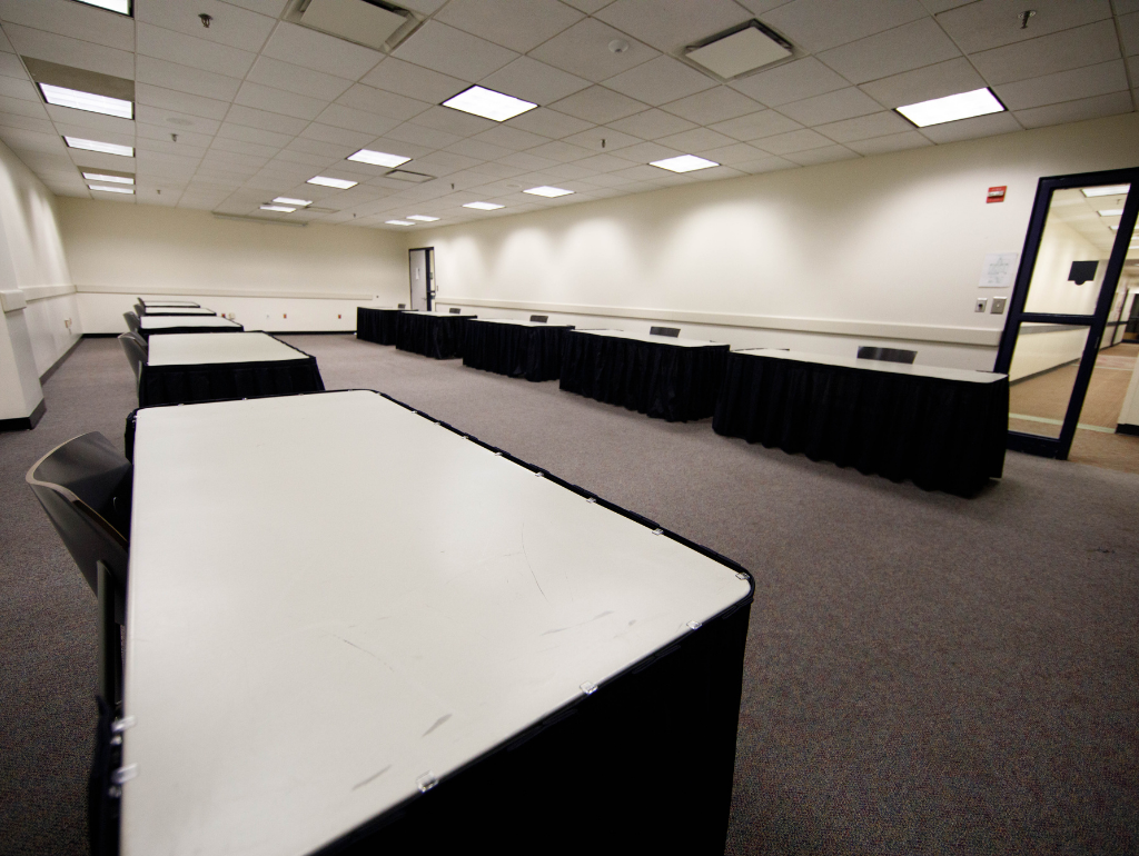 6ft tables with linens arranged along the walls of an interior USC meeting room