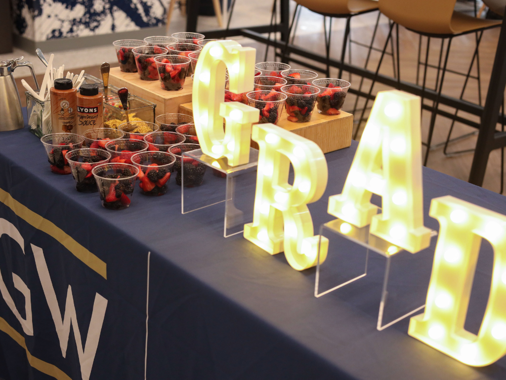 Table with sweets and light up letters that spell "GRAD"