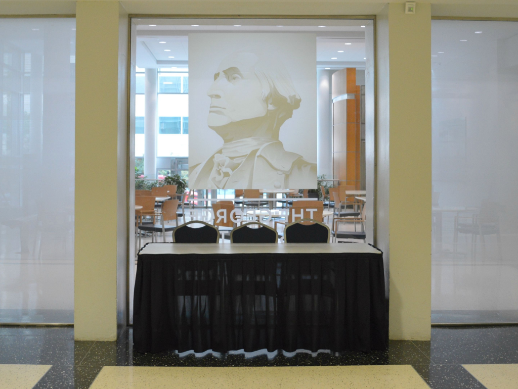 Table and chairs set up on the first floor of the USC outside the elevators