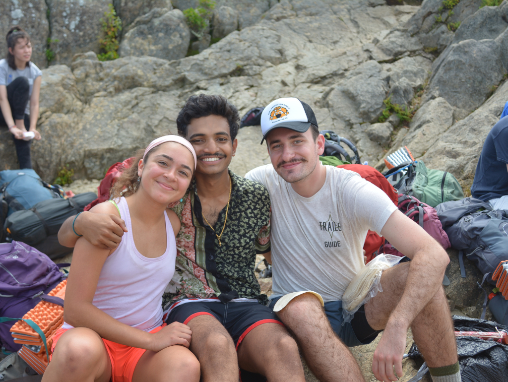 TRAiLS Guide posing for a photo with fellow hikers on a mountain