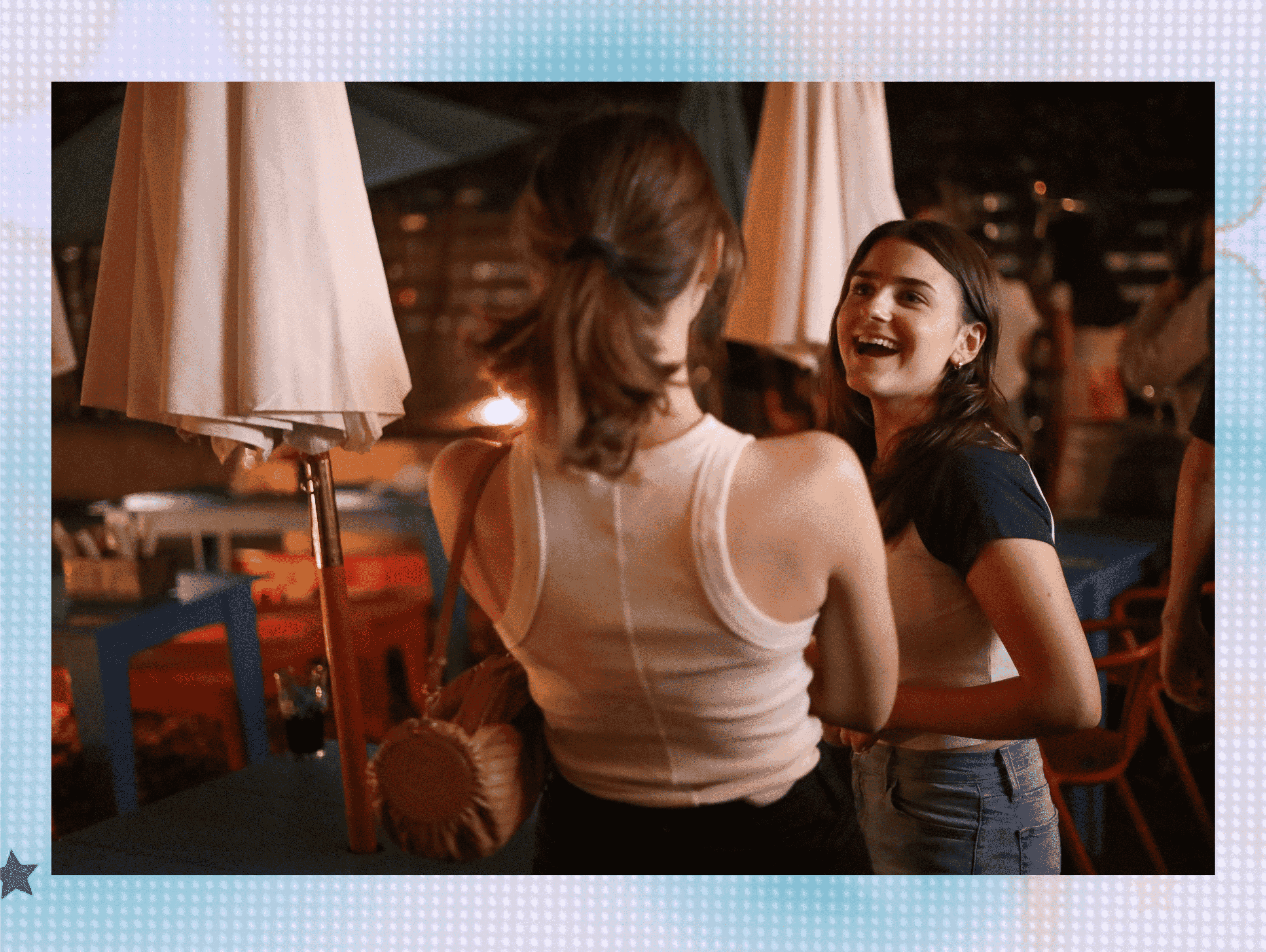 Two girls stand near a fire pit at Tonic