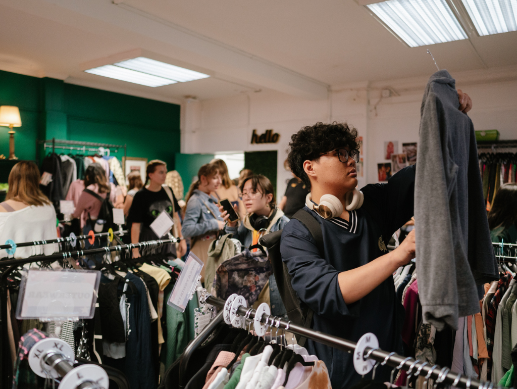 Students browsing racks of clothes at The Loop on the Vern